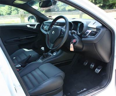 Alfa and Giulietta branding runs through from key fob and pedals to carpet mats and sill embellishers