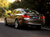 A rear view of the BMW 3 Series sedan in motion